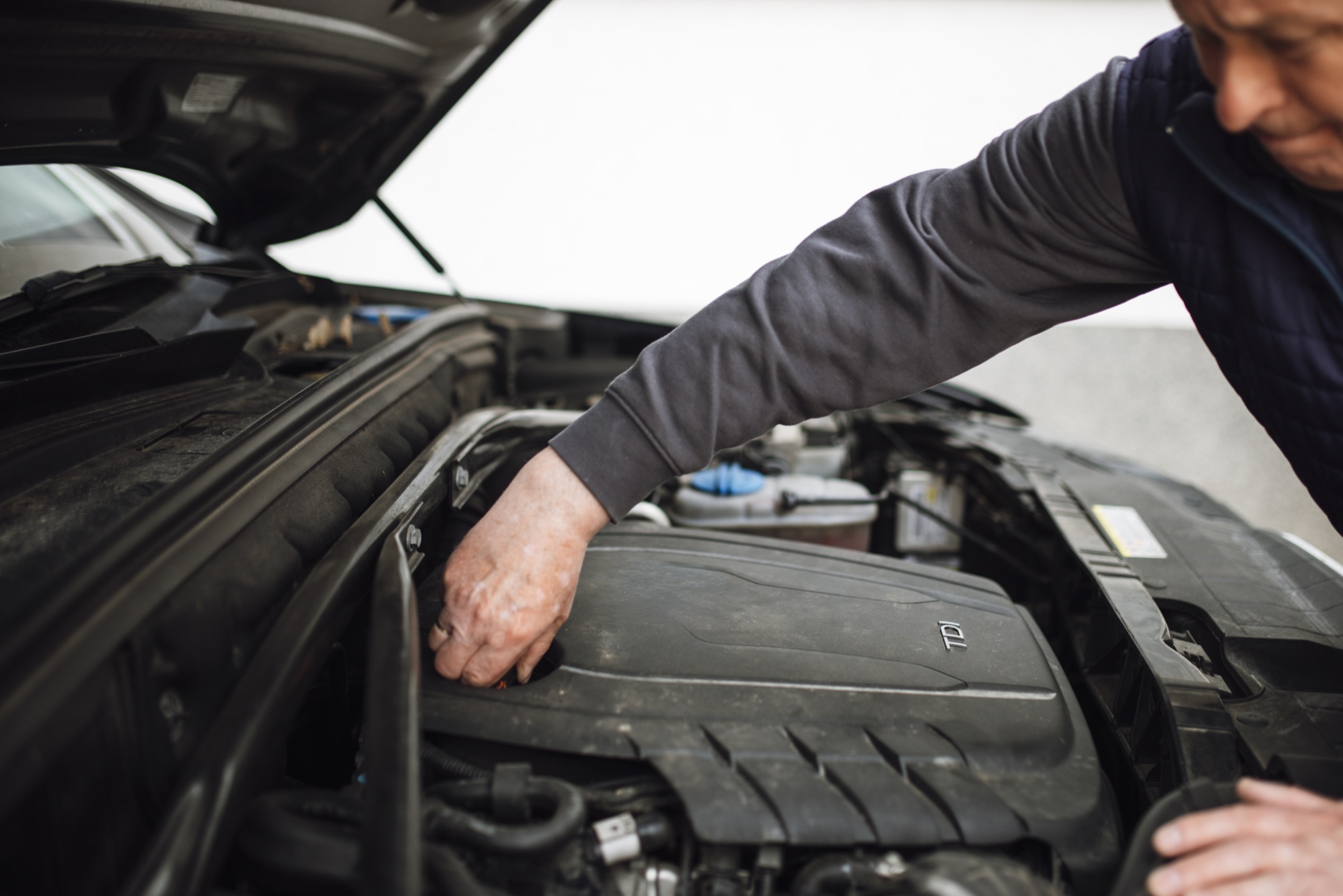 Mechanic inspecting a vehicle engine during routine maintenance